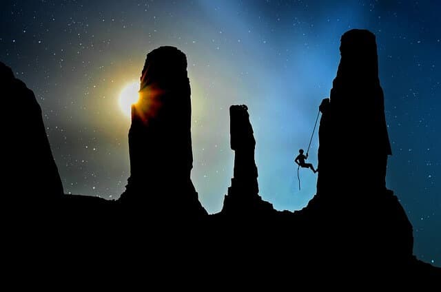 a person climbing up mountain